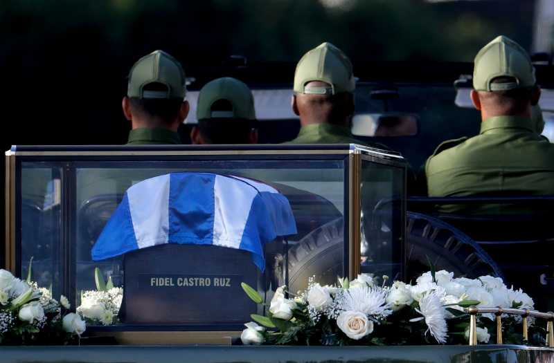 Placed in a small coffin covered by a Cuban flag the ashes of Cuban leader Fidel Castro are driven along the streets of Havana, Cuba, Wednesday Nov. 30, 2016. Castro's ashes have begun a four-day journey across Cuba from Havana to their final resting place in the eastern city of Santiago.(AP Photo/Natacha Pisarenko)